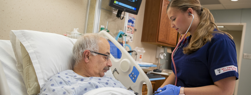 A School of Nursing student checks a patient’s vital signs.