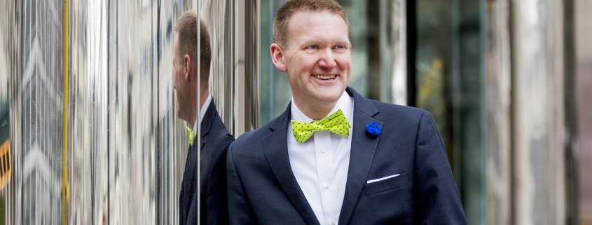 Alumnus Cris Dorman stands in downtown Indianapolis, wearing one of the bowties made by the company he helped start, Rock My Bow Tie.