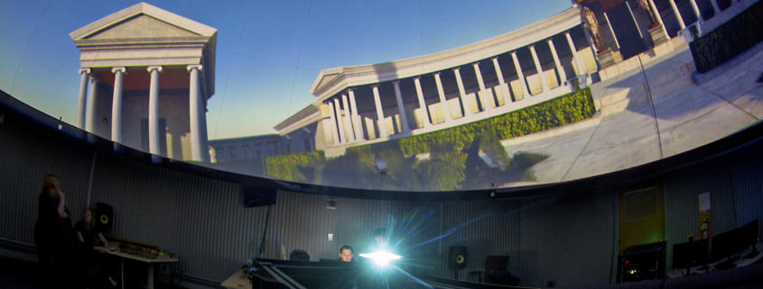 A projector illuminates the dome of Ball State’s old planetarium with an image.