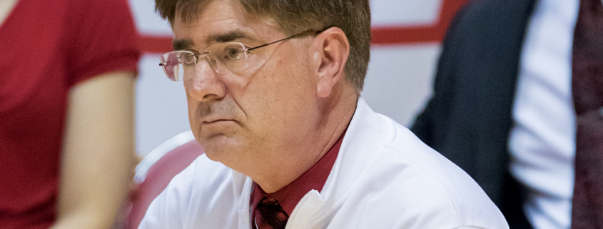 Steve Shondell is seen kneeling along the sidelines during a Ball State women’s volleyball match.