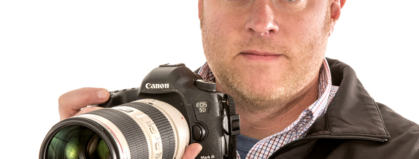 Chris Flook, a telecommunications lecturer at Ball State University, poses with his camera.