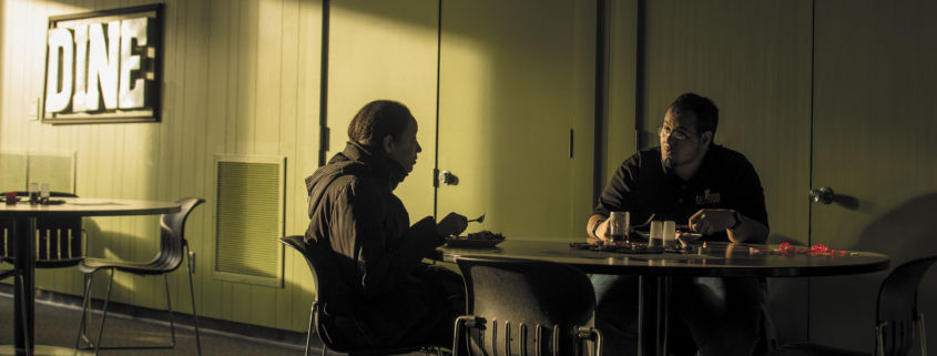 Two students grab a bite to eat in a dining hall in Lafollette Complex during Ball State Dining’s energy-saving Dinner in the Dark event.