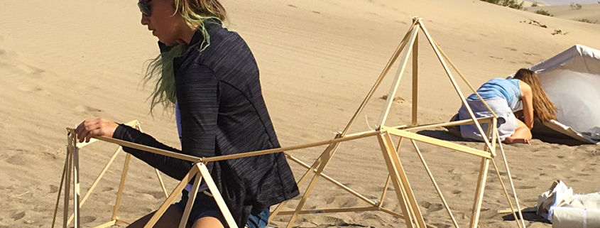 An architecture student builds a shelter she designed during a recent trip she and other students took to California's Death Valley